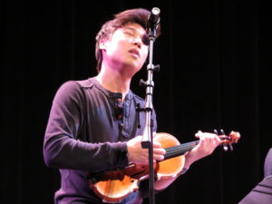 Charles "Charlie" Yang sings a verse to the group's encore performance of "Vertigo," an original love song written by a friend of the group,.