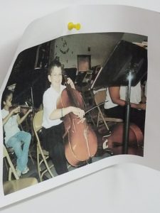 A photo of elementary-school Turner playing cello hangs in Dr. Hawkins' office. He and his parents made a deal that he could return to orchestra after one year trying bassoon, but instead he stayed in band.