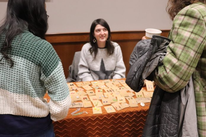 Students visit Alice Beatty at her jewelry booth